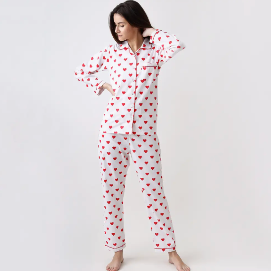 Elegant Hearts collection pajamas from Little West Street, designed with a notched collar top and matching bottoms in a signature print with contrast cording. The superfine cotton pajamas come in a matching fabric gift bag, embodying luxury, comfort, and thoughtful craftsmanship.