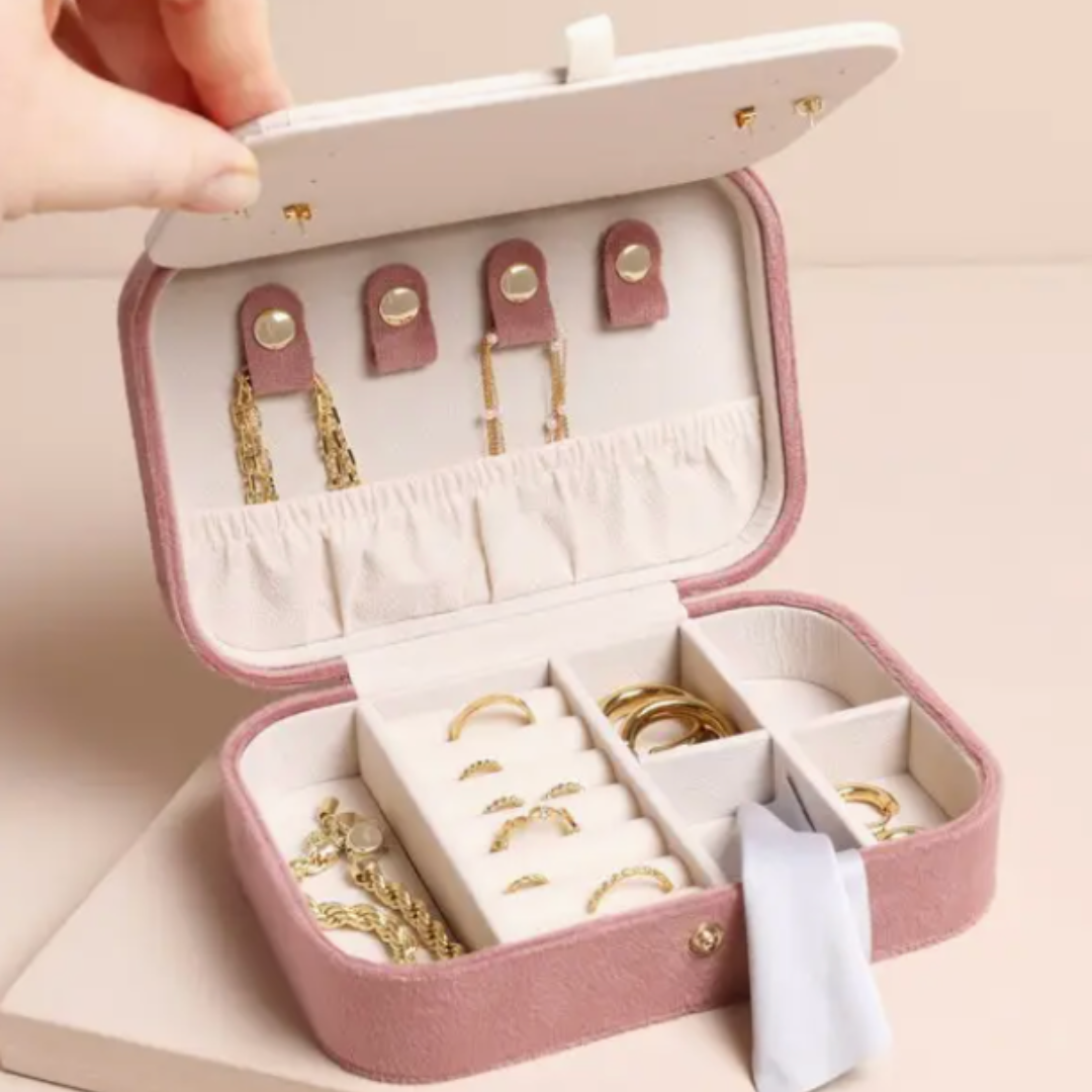 Elegant velvet jewelry box with a built-in mirror, stud holes for eight pairs of earrings, ring rolls, and hidden necklace hooks with a storage pouch.