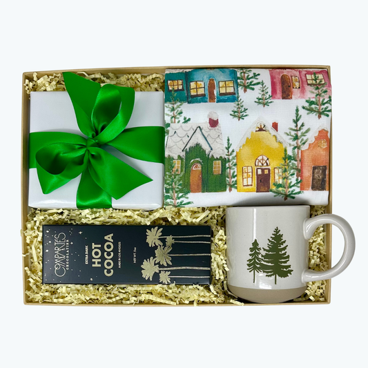 Gift set with mug, hot cocoa mix, and winter-themed towel in a decorative box.