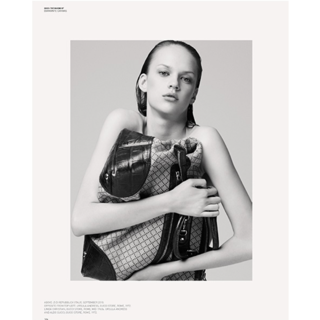 Black and white photo of a female Gucci model with wet hair clutching a Gucci bag.