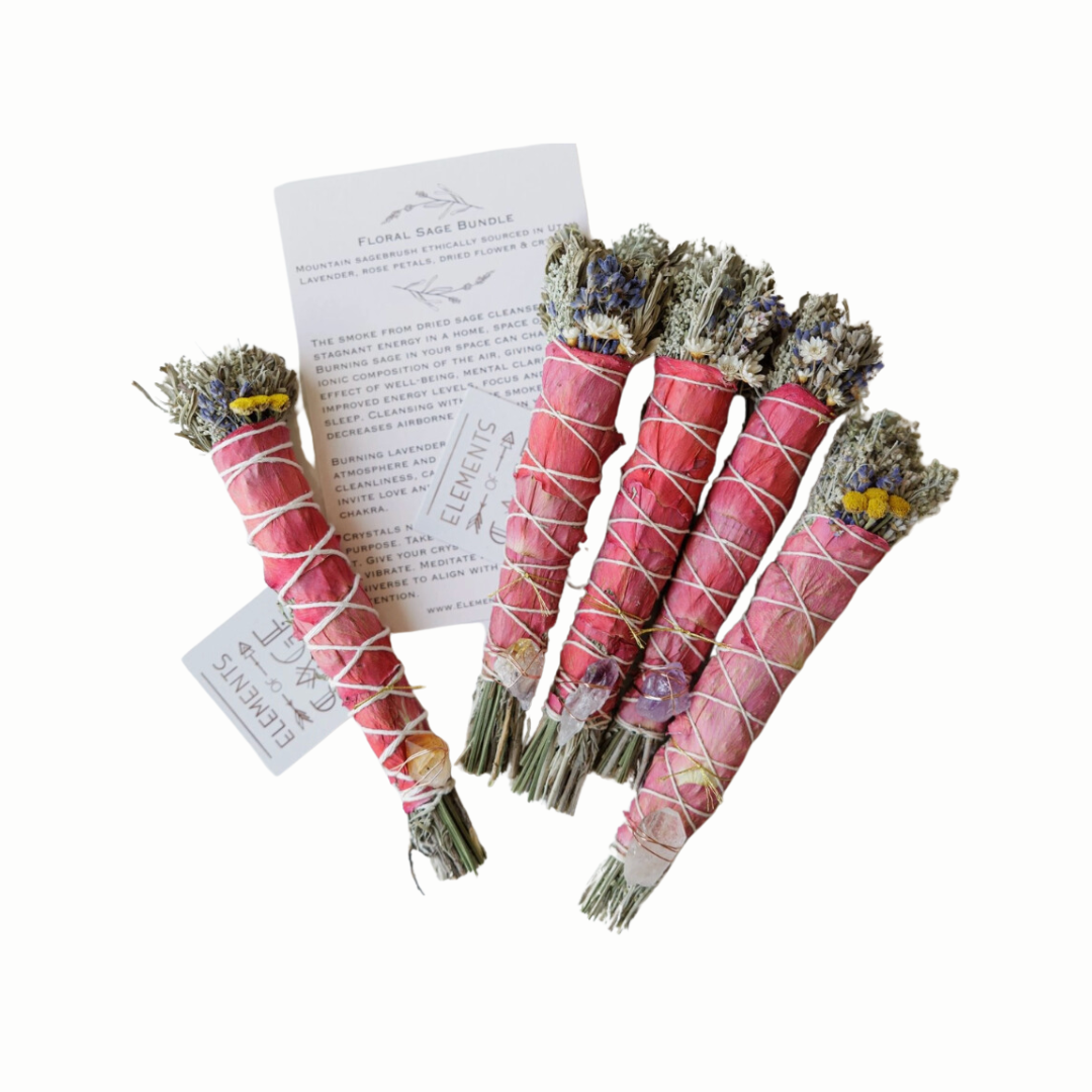 A Floral Sage Bundle featuring mountain sagebrush and a blend of herbs and dried flowers, adorned with a choice of amethyst, clear quartz, or citrine crystal. The bundle is displayed with a calming, natural backdrop