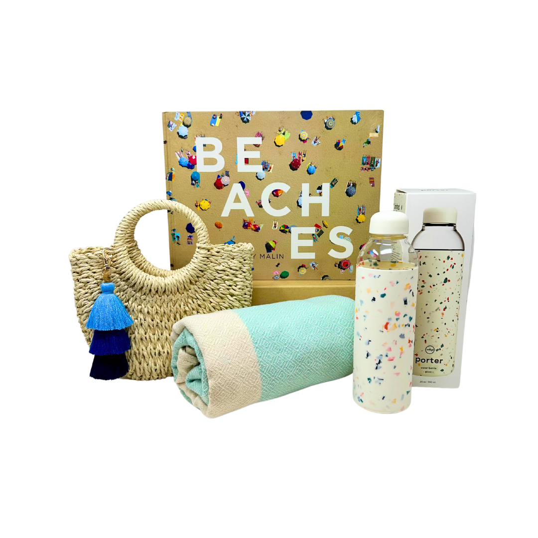Chic beach vibes: Straw bag with blue ombre tassel, glass and silicone water bottle, & blue peshtemal towel. Fun In The Sun Me To You Box care package.