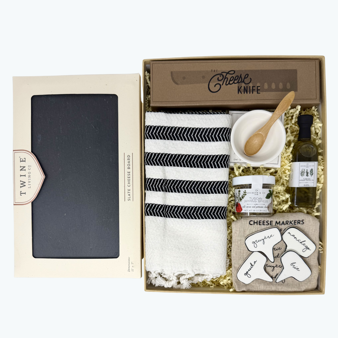 Gift set with cheese board, towel, cheese knife, olive oil, spices, oil dish and spoon , and cheese markers in a box.