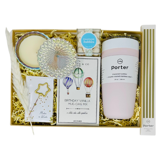     Elegant "HAPPY BIRTHDAY WISHES" gift box filled with a selection of birthday treats: a 20 oz insulated tumbler, vanilla mug cake mix, champagne-flavored gummies, and a petite shimmer candle. The box is ideal for making birthday celebrations special and is accompanied by a card that adds a sparkling touch to the gift.