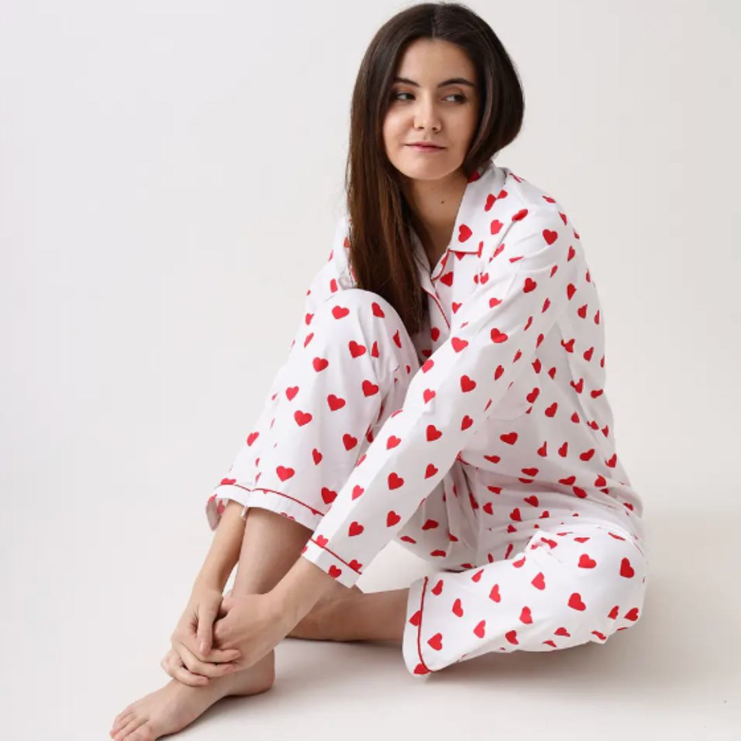 Hearts collection pajamas by Little West Street, crafted from 100% luxury cotton with a notched collar top and coordinated pajama bottoms. The set, featuring a limited edition print and contrast cording, is beautifully packaged in a matching fabric gift bag, perfect for gifting or personal use.