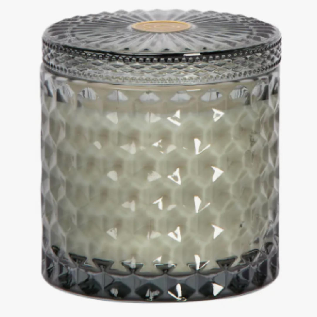 Heathered Suede Shimmer Candle is a 15oz double wick soy wax candle in a beautiful grey, cut glass vessel with matching lid.