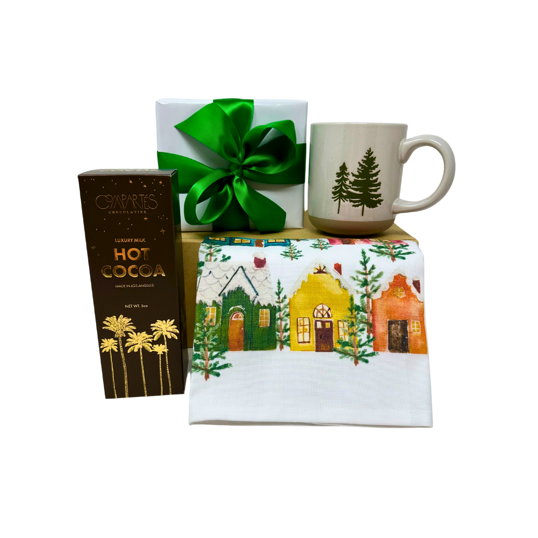 Gift set with mug, hot cocoa mix, towel, and wrapped gift on a white background.