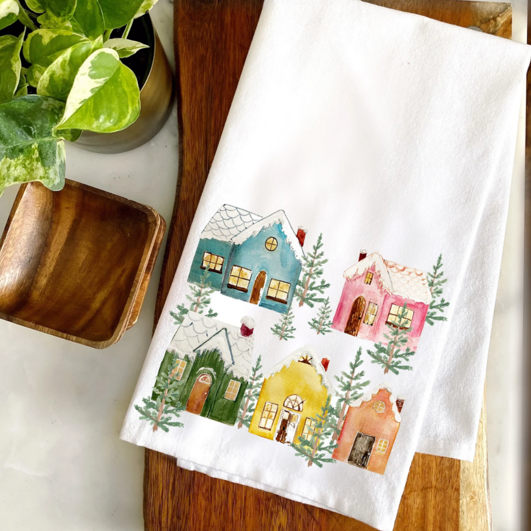 White towel with colorful house design on a wooden surface