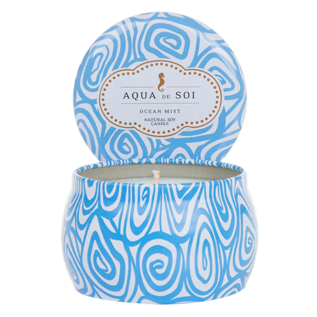 Blue and white 4 oz swirl tin candle by Aqua De Soi: Ocean Mist scent, a refreshing natural soy blend for a tranquil ambiance.