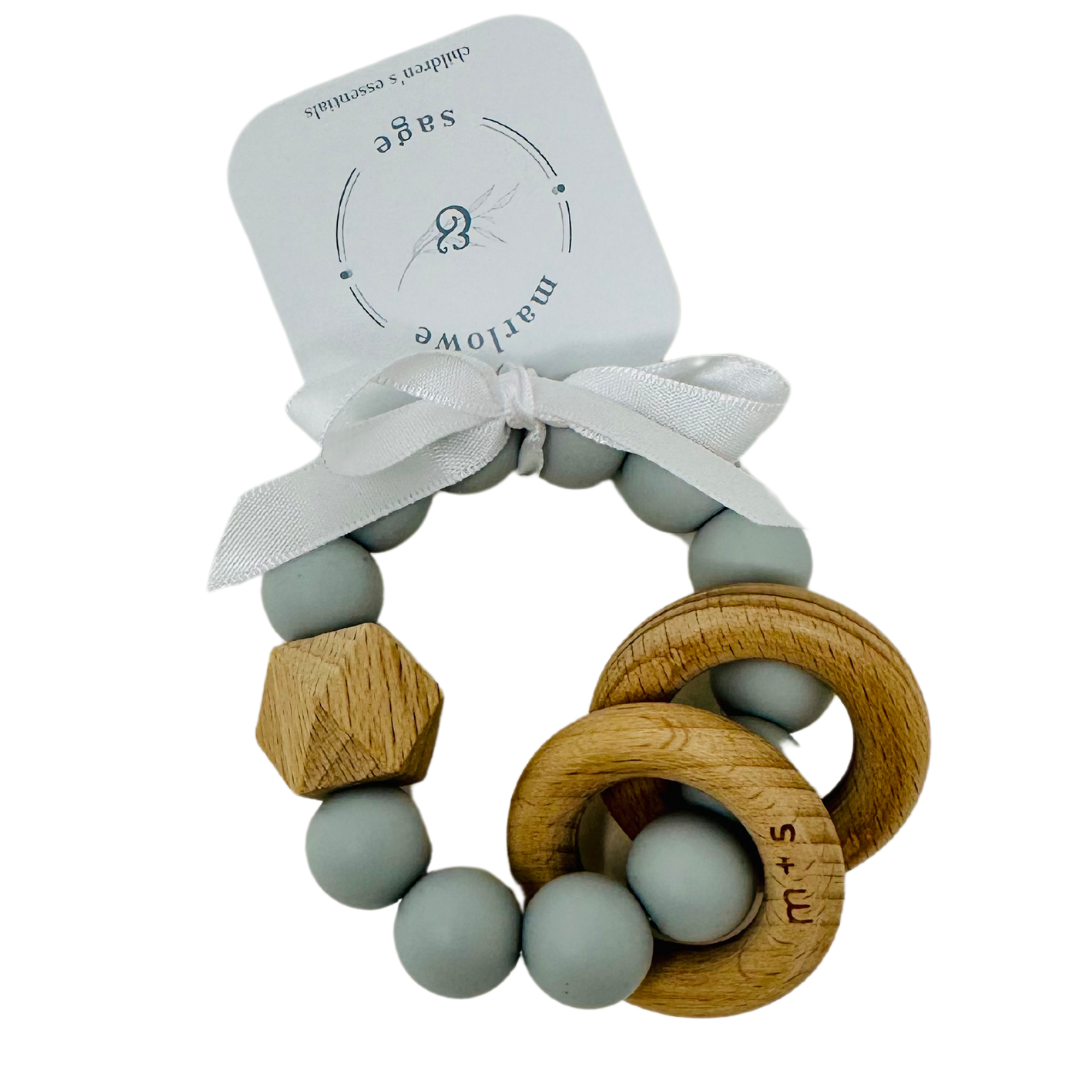 Handcrafted beech wood heart and circle baby rattle with gray silicone beads, safe and soothing for little hands.