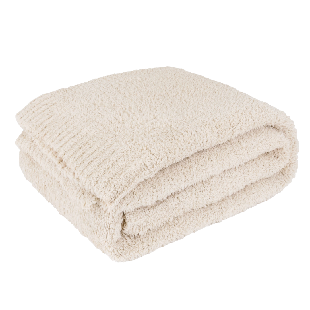 Folded cream blanket on a white background.
