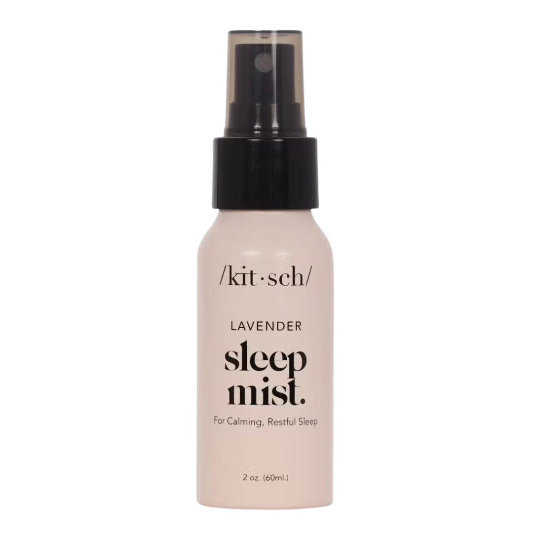 Lavender Calming Sleep Mist with soothing scents of lavender, balsam, and vanilla to promote relaxation and restful sleep, perfect for bedtime routines. 2 ounce mist in a petal pink spray bottle with black top and black writing.