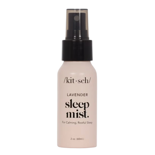 Lavender Calming Sleep Mist with soothing scents of lavender, balsam, and vanilla to promote relaxation and restful sleep, perfect for bedtime routines. 2 ounce mist in a petal pink spray bottle with black top and black writing.