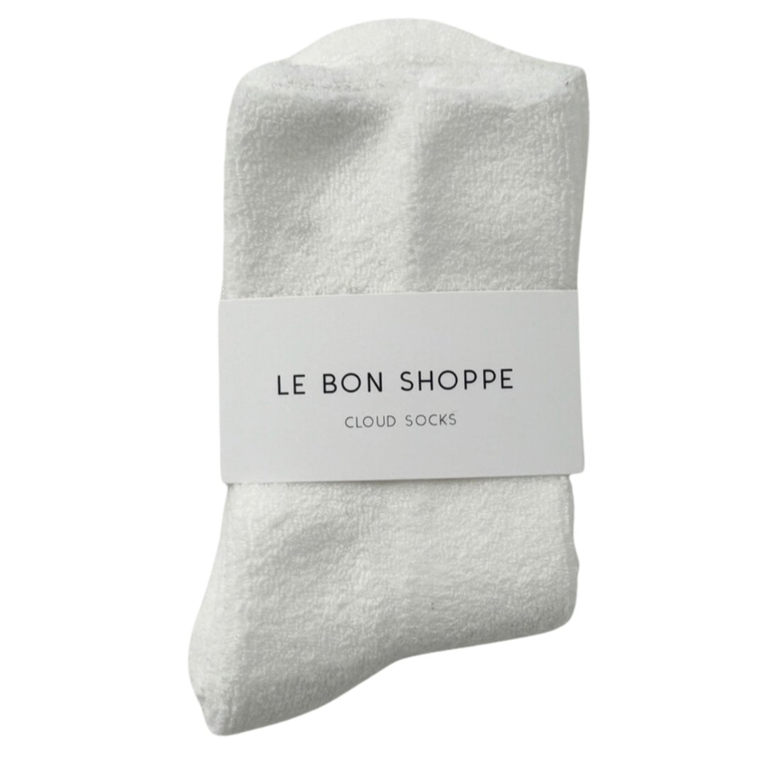 Pair of soft, white cozy socks with a plush texture, perfect for keeping feet warm and comfortable on chilly days.