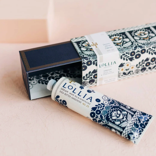 Lollia hand cream with decorative packaging on a light pink background