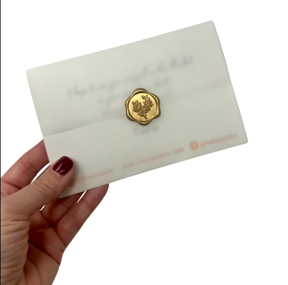 4x6 custom gift card wrapped in vellum and sealed with a gold wax seal.