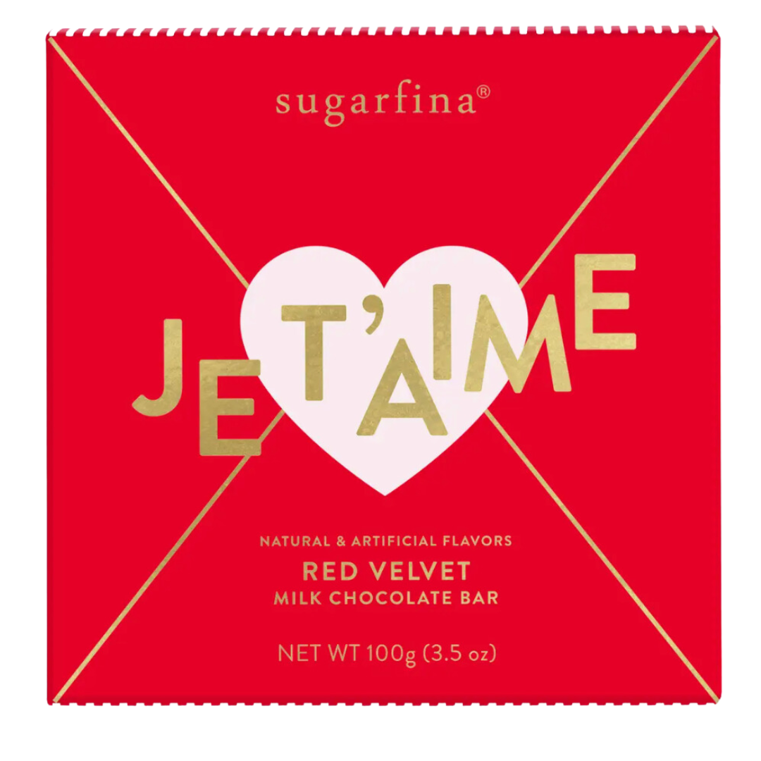 A luxurious 3.5oz milk chocolate bar by Sugarfina, featuring a rich red velvet-flavored center. Perfect for gifting or indulging in a sweet treat from candy cupid. The vibrant red packaging has a pink heart in the middle and the word Je t'aime in gold that means I love you in French!