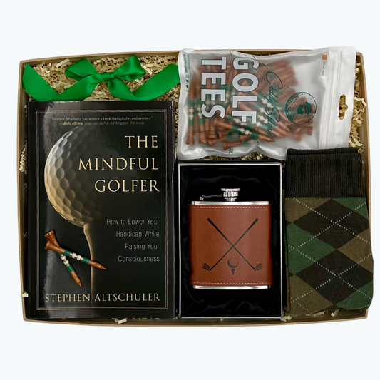 Gift set with 'The Mindful Golfer' book, flask, and golf tees in a box.