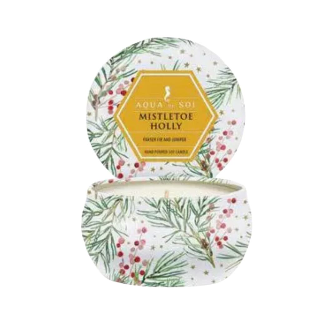 Aqua de Soi's Mistletoe & Holly soy candle. Hand-poured and eco-friendly, this 4-ounce candle features a mix of Fraser fir, balsam cedar, and juniper berry, providing a long-lasting, clean burn for a cozy atmosphere.