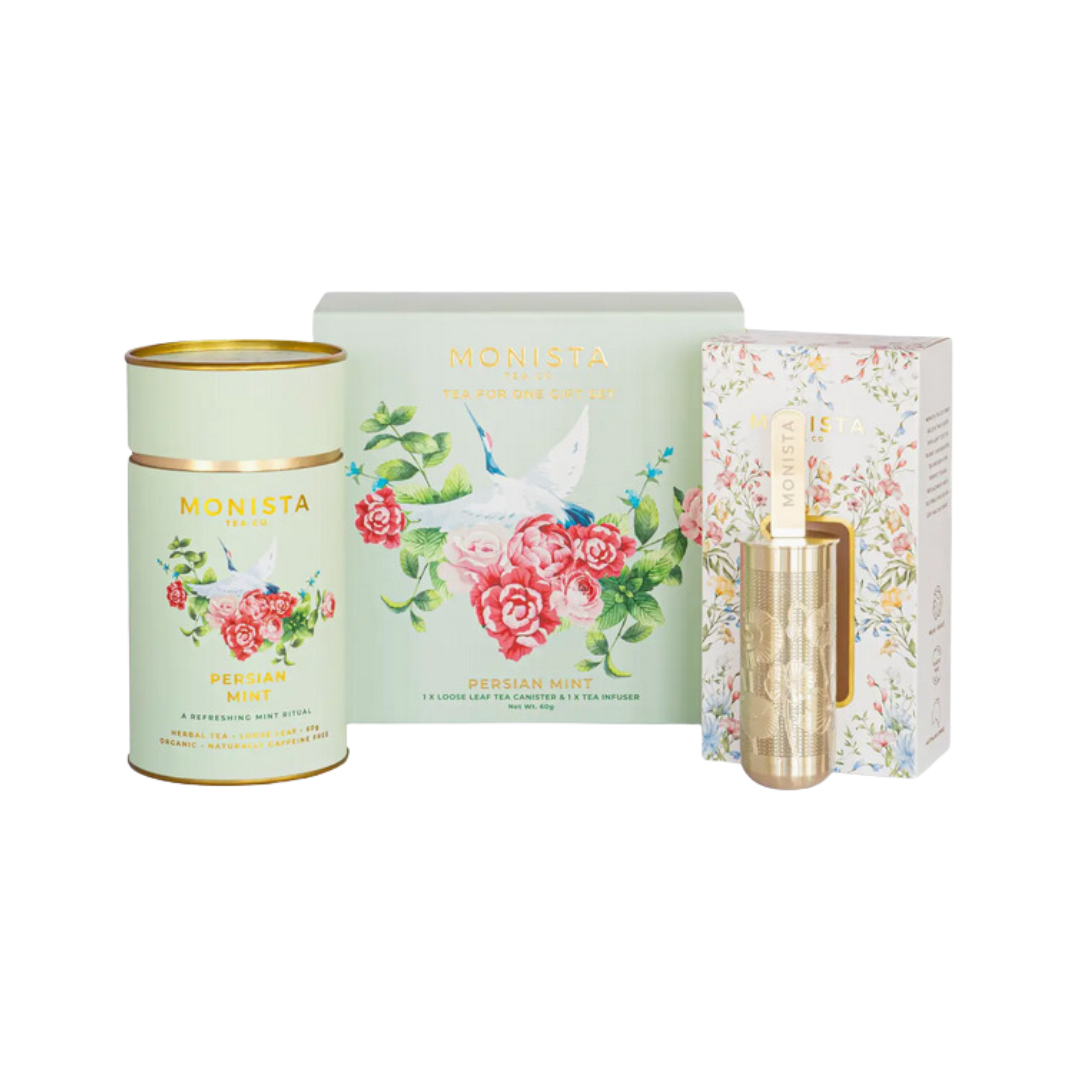 A beautifully packaged gift set featuring Monista Tea Co's Organic Persian Mint Tea and a gold stainless steel tea stick infuser, displayed against a soft, neutral background.