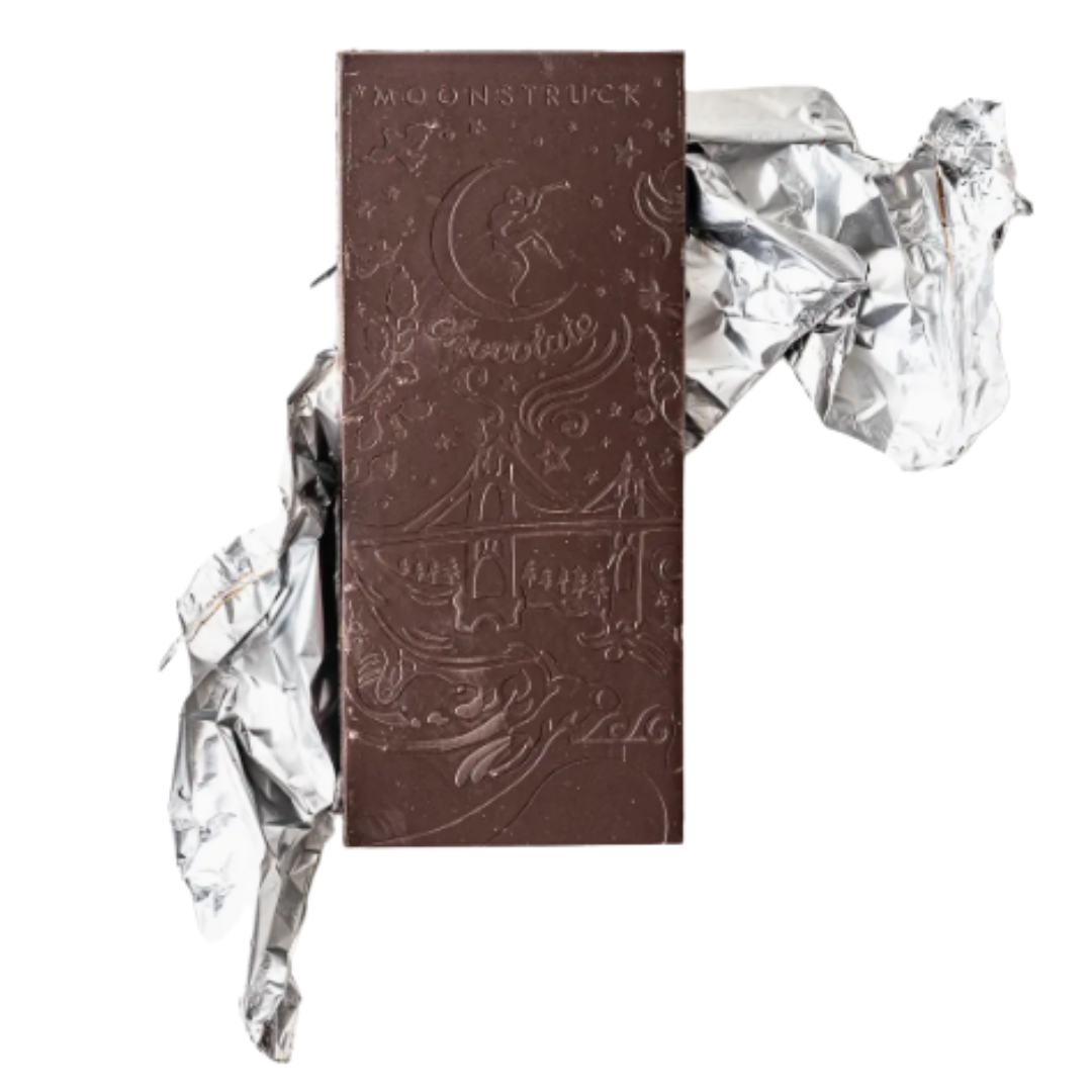 Chocolate bar with decorative packaging and crumpled foil on a white background.