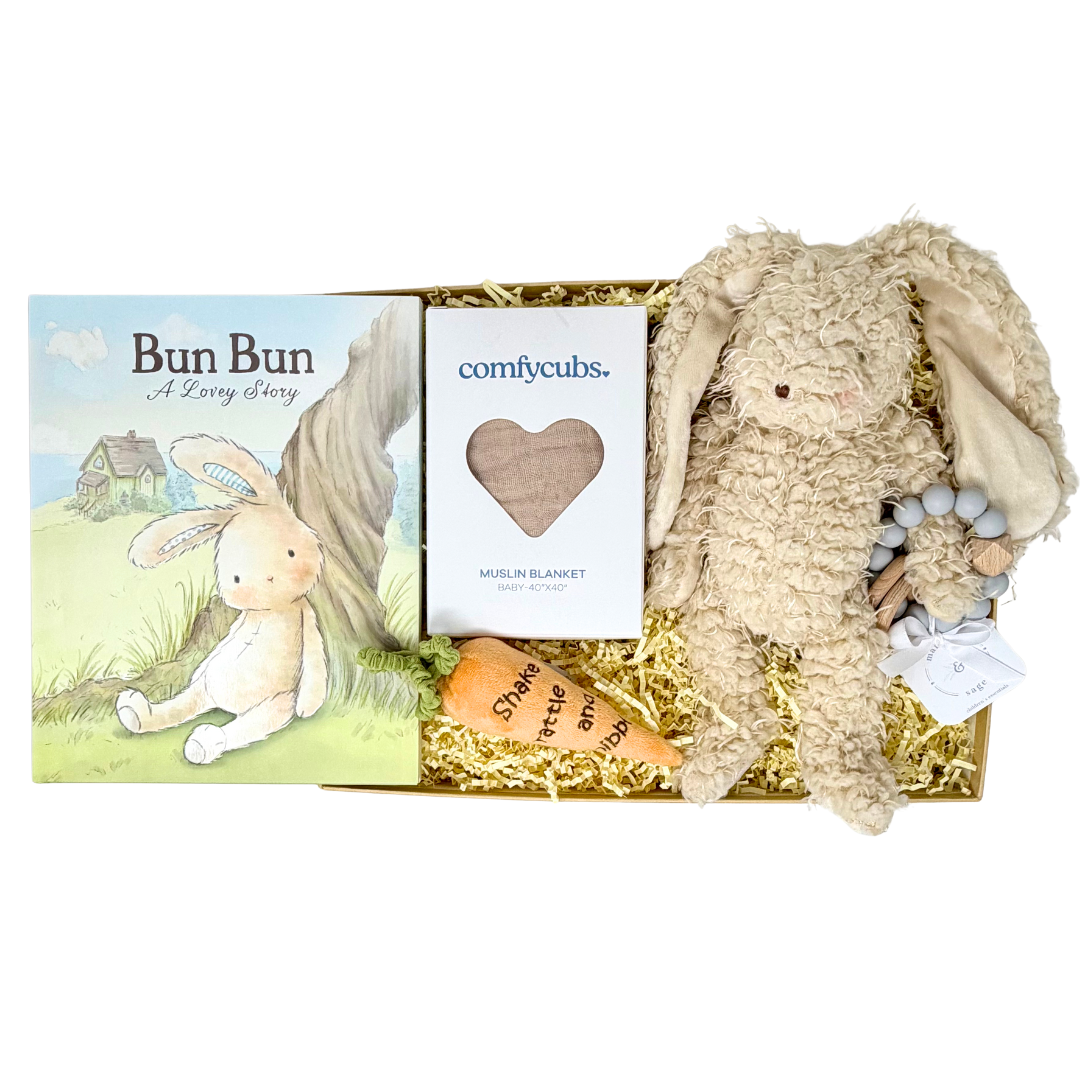 Gift set with a plush bunny, plush orange carrot, blanket, teether, and book titled 'Bun Bun' on a white background.