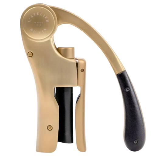 Sleek gold wine opener in motion on a white background.