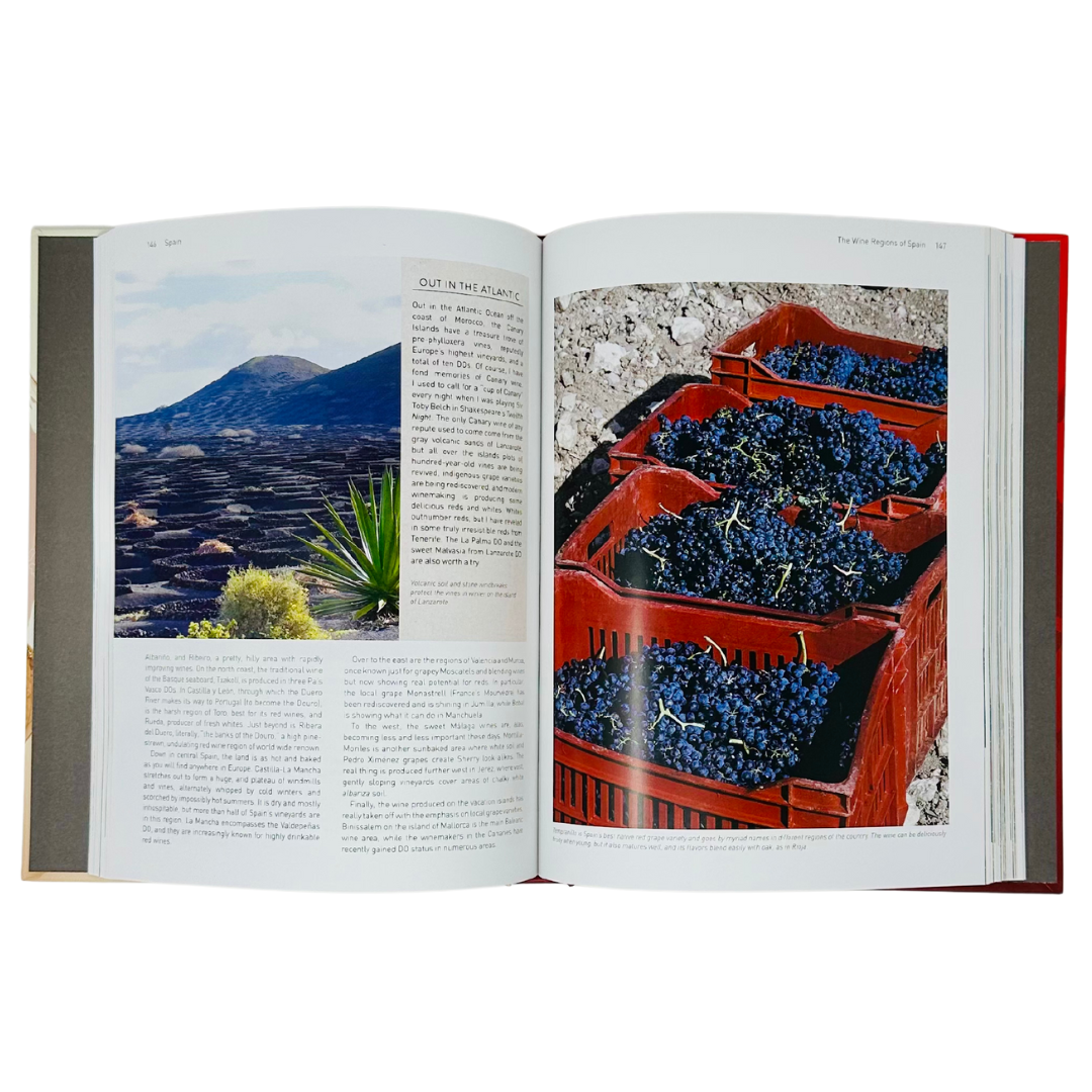 Vibrant vineyard scene with overflowing grape baskets, featured in Oz Clarke's Hardcover Coffee Table Book.