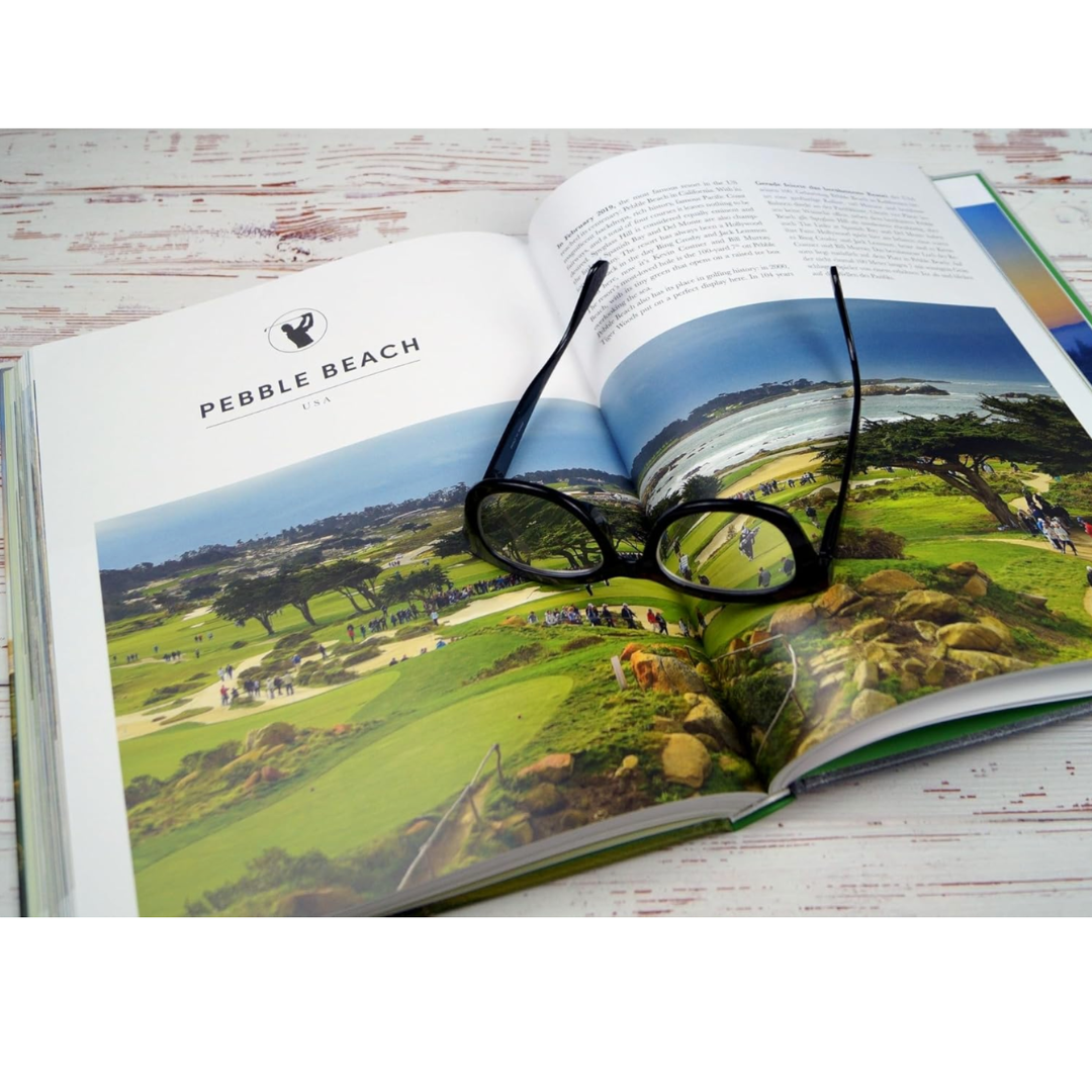 Open book with a scenic view of Pebble Beach and eyeglasses on top.