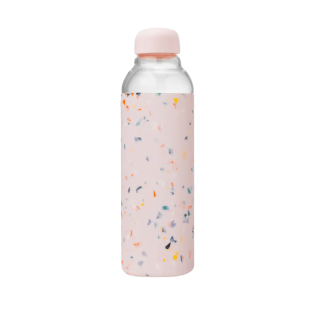 Blush pink terrazzo glass water bottle featuring pink silicone wrap, 100% food-safe and soft to the touch.