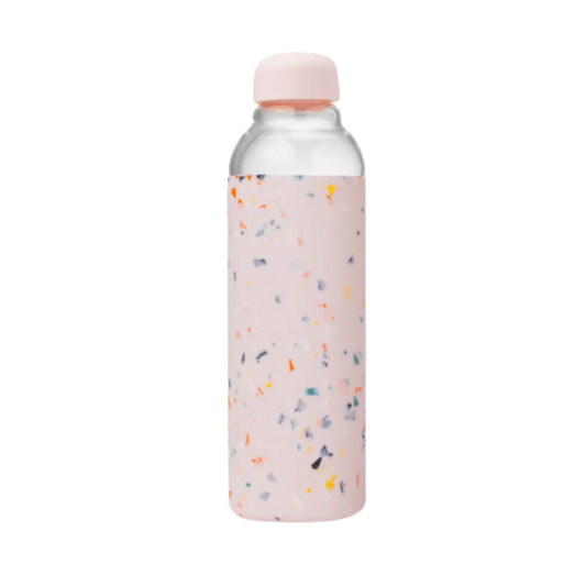 Blush pink terrazzo glass water bottle featuring pink silicone wrap, 100% food-safe and soft to the touch.