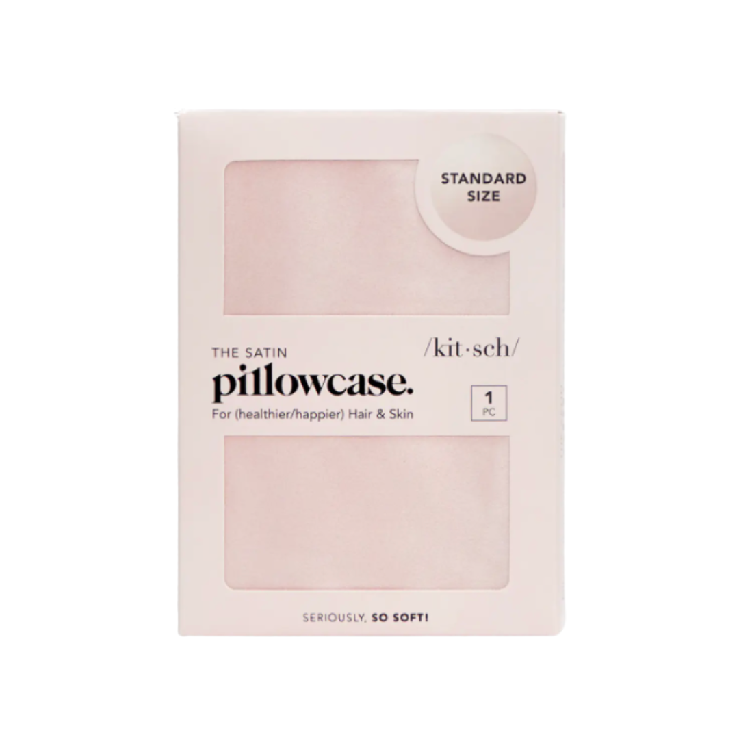 Kitsch pink satin pillowcase in packaging on a white background.