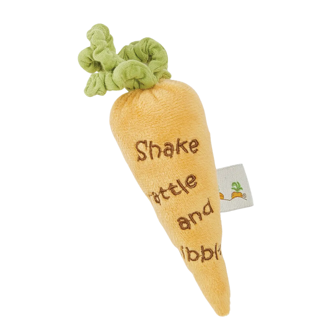 Carrot-shaped orange plush toy with text that says, shake, rattle and nibble, on a white background.