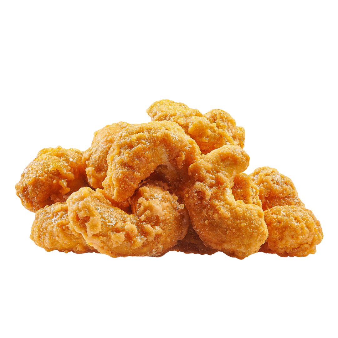 Pile of spicy cashew pieces on a white background.