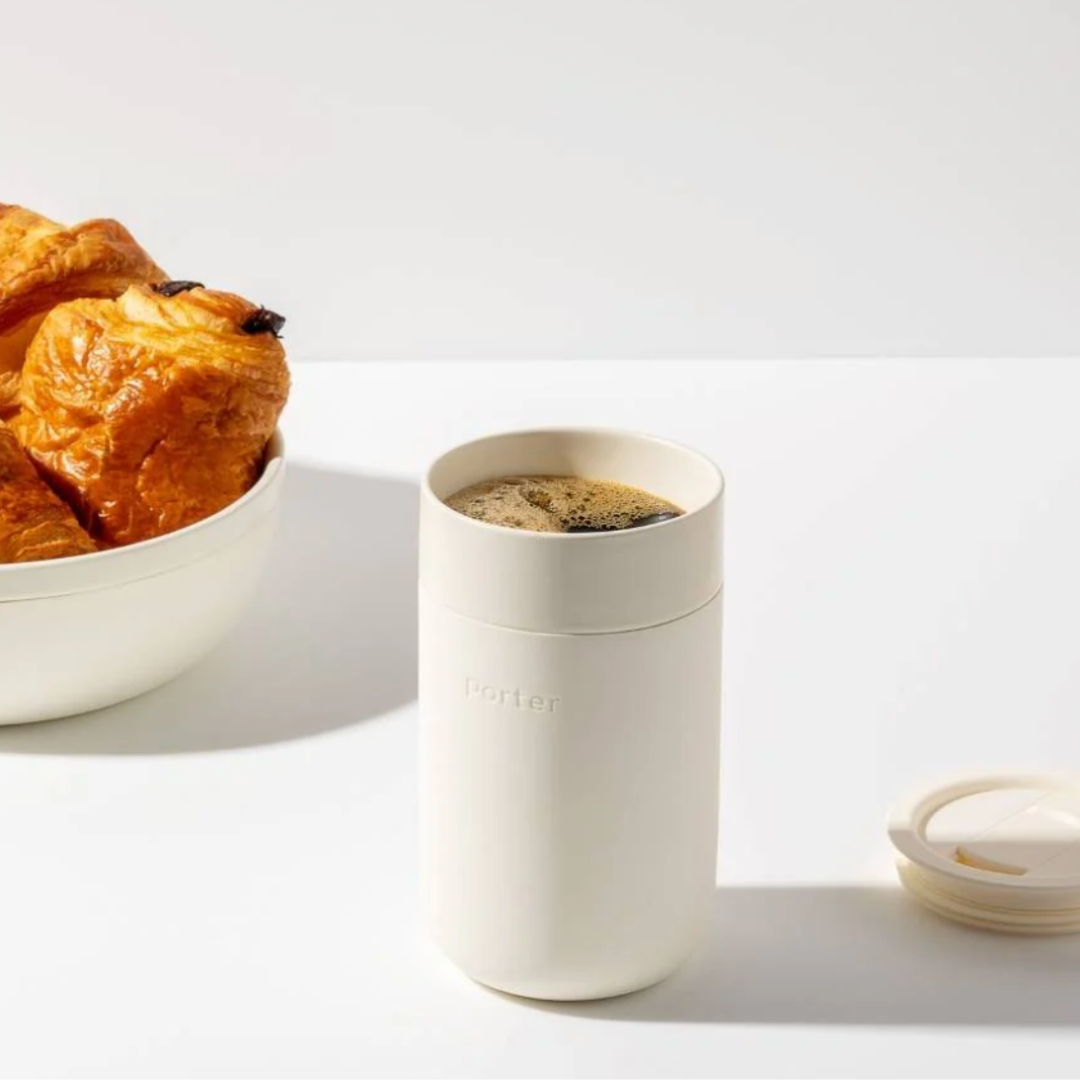 A cream-colored 16 oz mug wrapped in silicone for a comfortable grip, featuring a sleek and modern design.