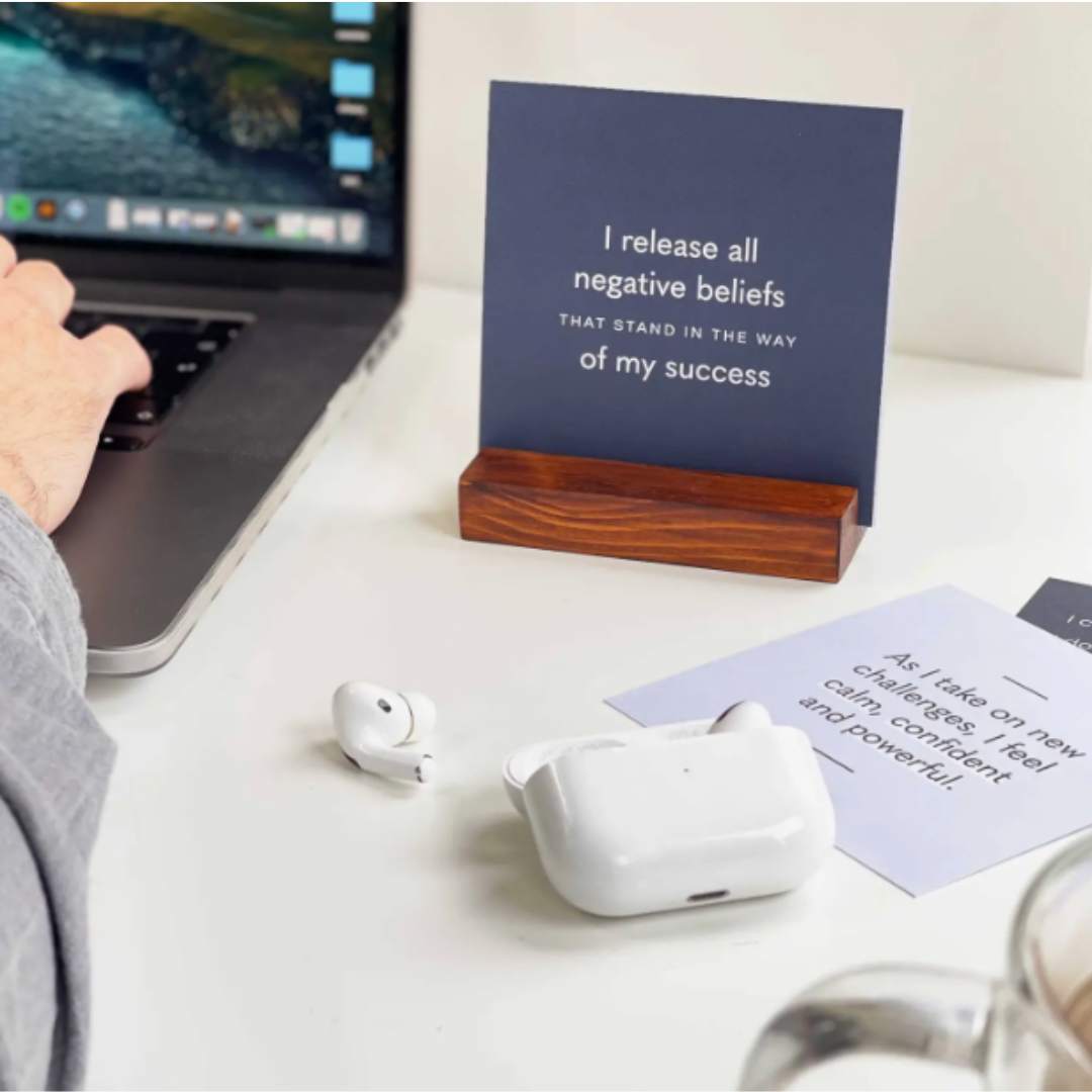 Positive affirmation card pack with wood stand tailored for men and boys, including 10 double-sided cards with inspirational "I am" messages. The cards feature striking designs with deep blue tones on one side and white to green gradients on the other, providing both motivational content and stylish desk decor.