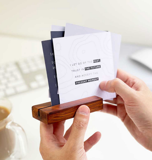 A collection of motivational cards resting on a wooden stand, ready to inspire.