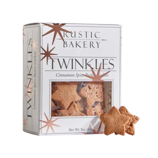 A charming white box with clear window filled with Rustic Bakery's festive star cookies, showcasing delicate, holiday spiced butter cookies with a crisp texture, perfect for holiday gifting.