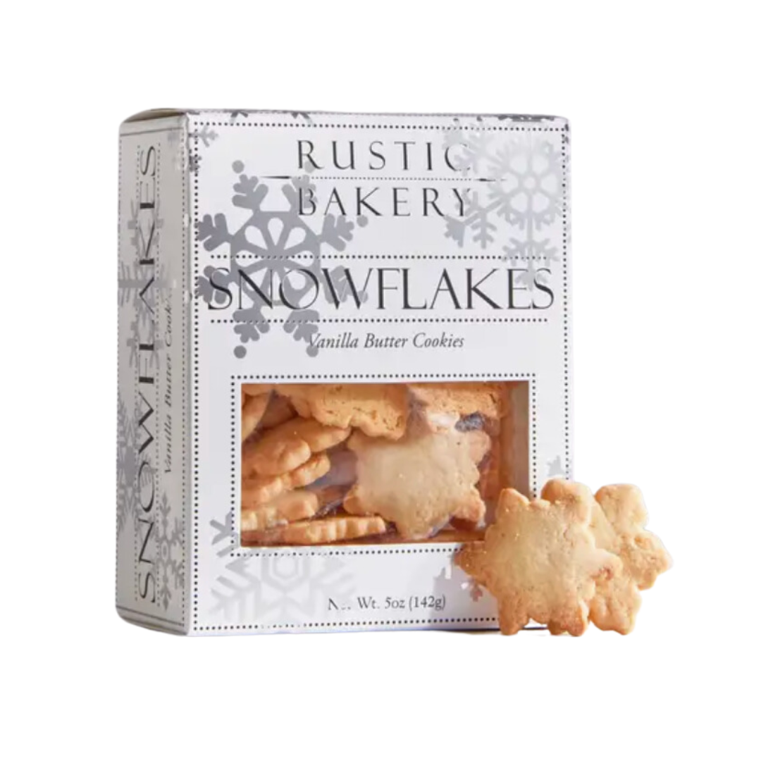 A beautiful box of Rustic Bakery's nostalgic cut-out snowflake cookies, delicately crafted with a crisp texture and a hint of Madagascar vanilla, evoking holiday traditions. The white  box is adorned with silver snowflakes.