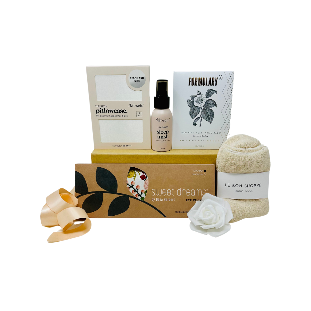 SATIN DREAMS Gift Box featuring satin pillowcase, lavender eye pillow, calming sleep mist, cozy cloud socks, and rosehip facial mask.