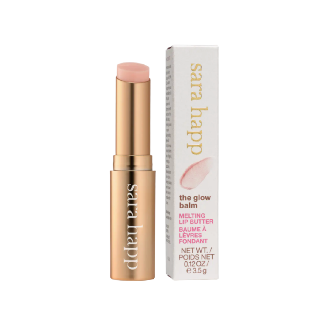 Sara Happ lip balm in gold tube with white and pink packaging on a white background.