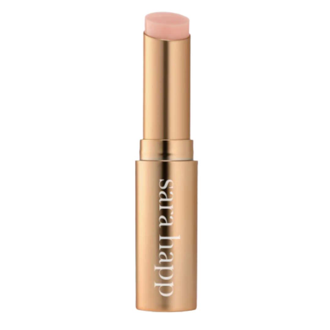 Gold tube of pink lip balm on a white background.