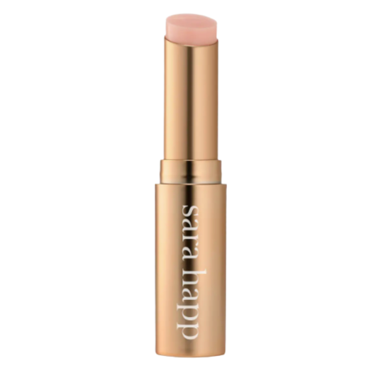 Gold tube of pink lip balm on a white background.