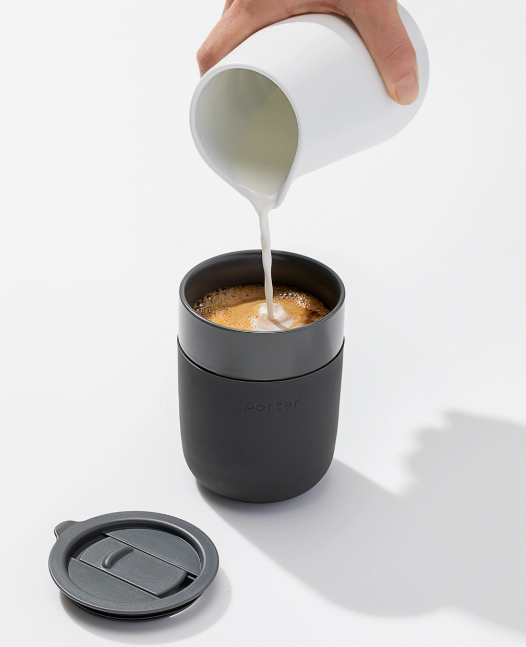 12 ounce charcoal ceramic mug with a charcoal silicone sleeve and sliding lid, showcasing a sleek and modern design by W&P.