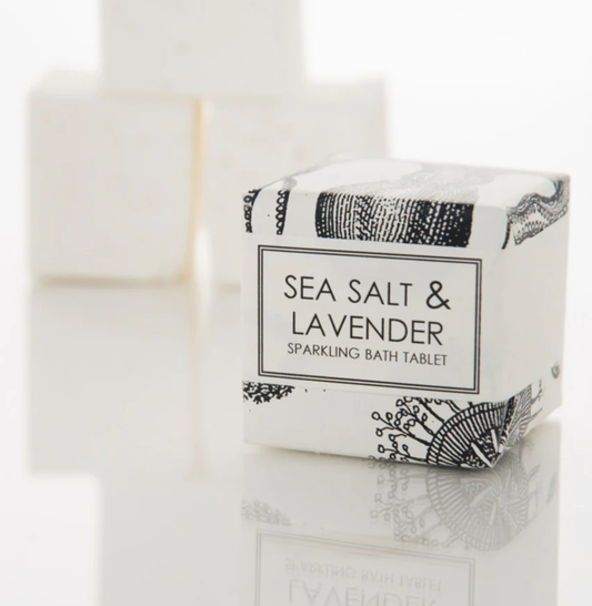 Black and white packaging of Sea Salt and Lavender Sparkling Bath Tablet by Formulary 55 on a white counter.
