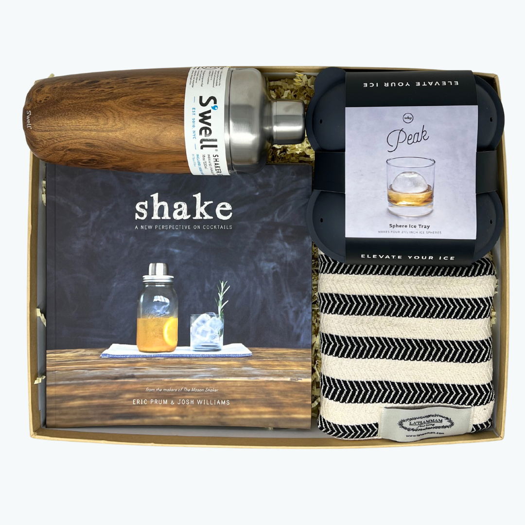Gift set with Swell shaker bottle, ice mold, cocktail recipe book, and towel in a box.