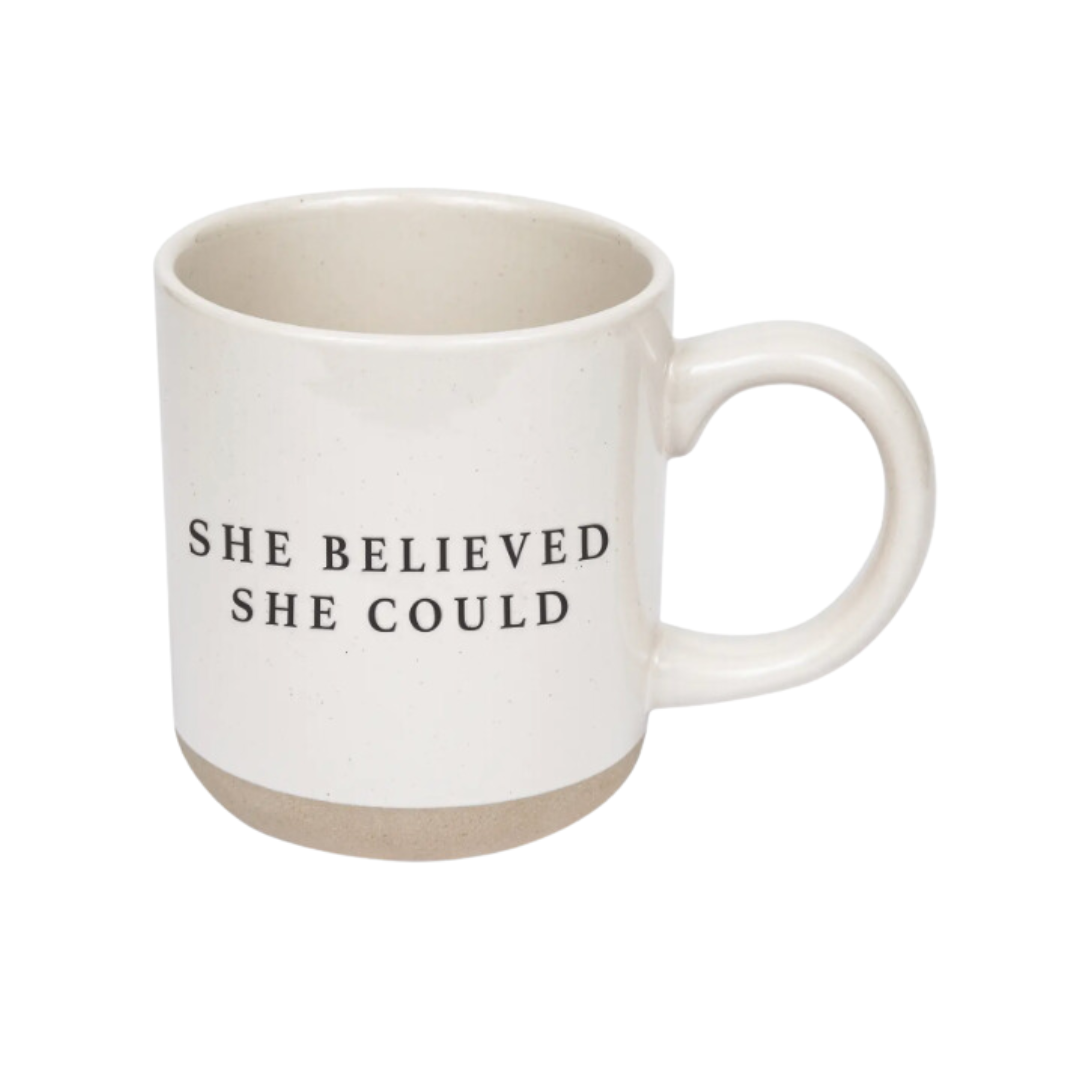 14oz stoneware mug with cream color and speckled design, featuring the inspirational phrase 'She Believed She Could' in black lettering on both sides.