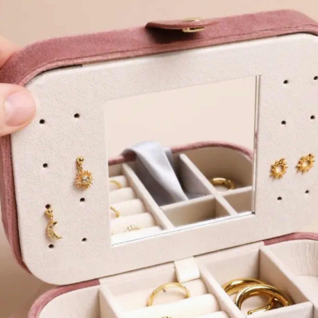 Sophisticated rectangular velvet jewelry case in rose pink with a popper closure, perfect for traveling and keeping jewelry secure and organized.