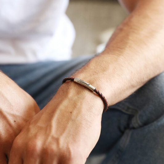 Stylish and modern woven brown leather bracelet for men, combining durability, comfort, and timeless style, ideal as a versatile accessory or thoughtful gift for him. The slim brown leather is shown on a man's wrist.