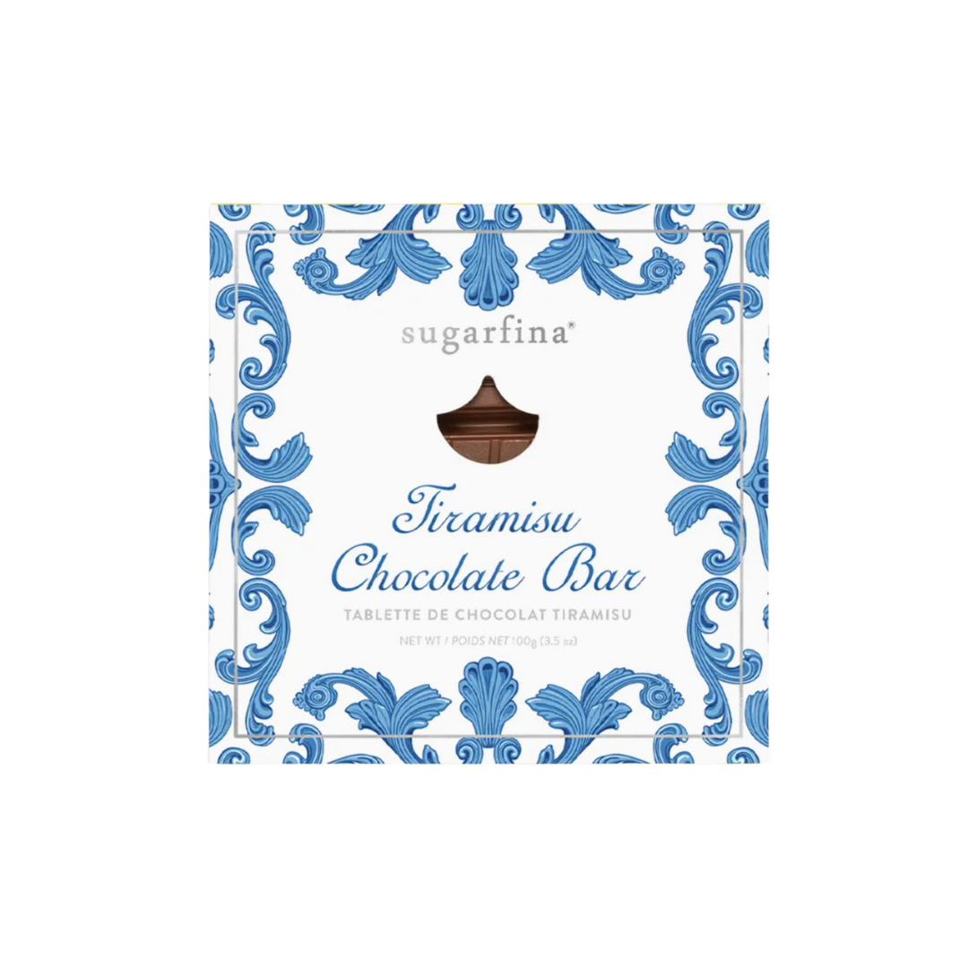 Indulge in Sugarfina's La Dolce Vita Tiramisu Chocolate Bar: A luxurious milk chocolate bar in a decorative blue and white wrapper featuring a creamy tiramisu-flavored center, perfect for gourmet chocolate lovers.